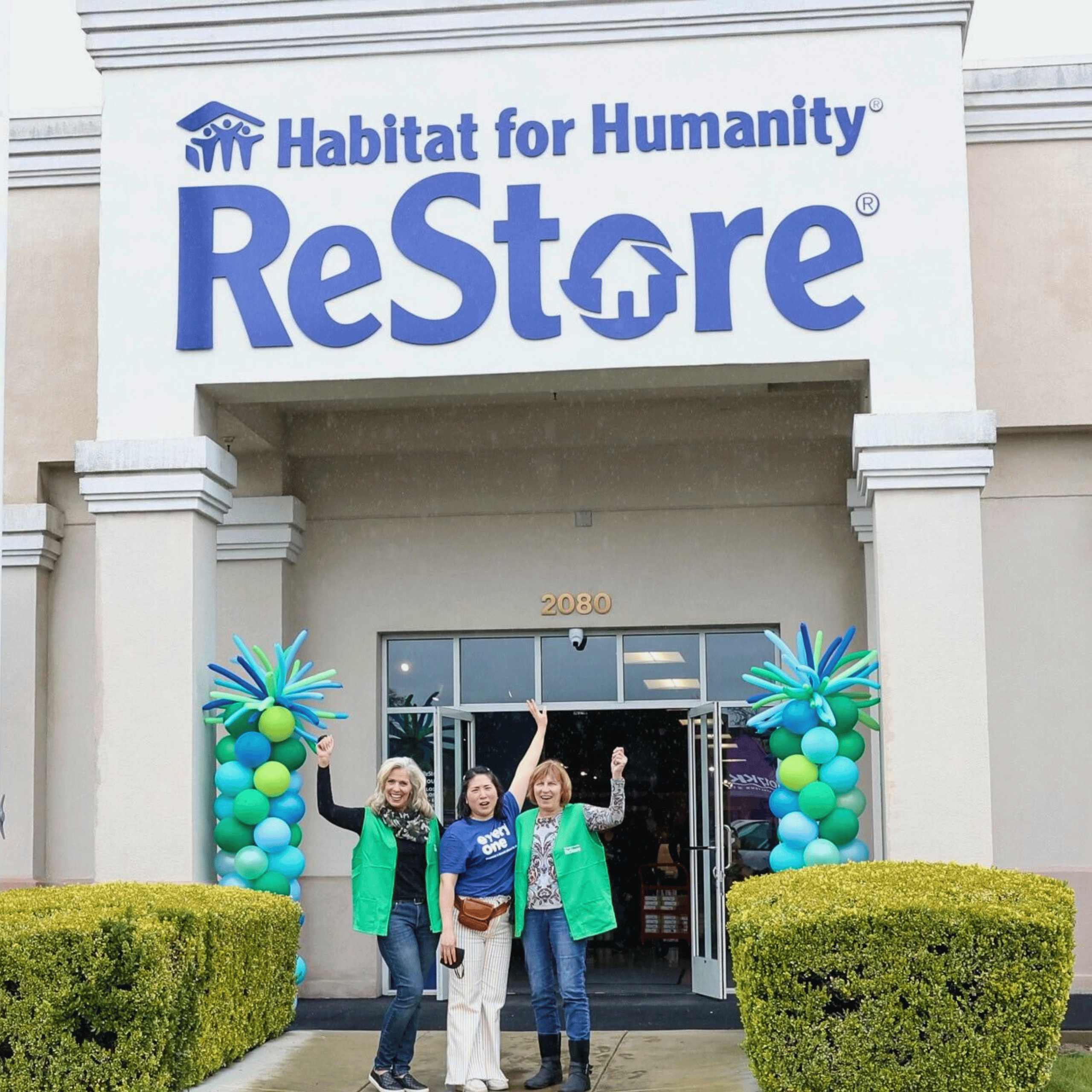 3 Volunteers Cheering Outside a Restore