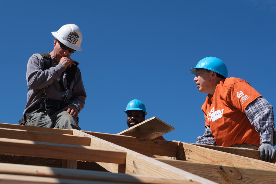 volunteers building a roof