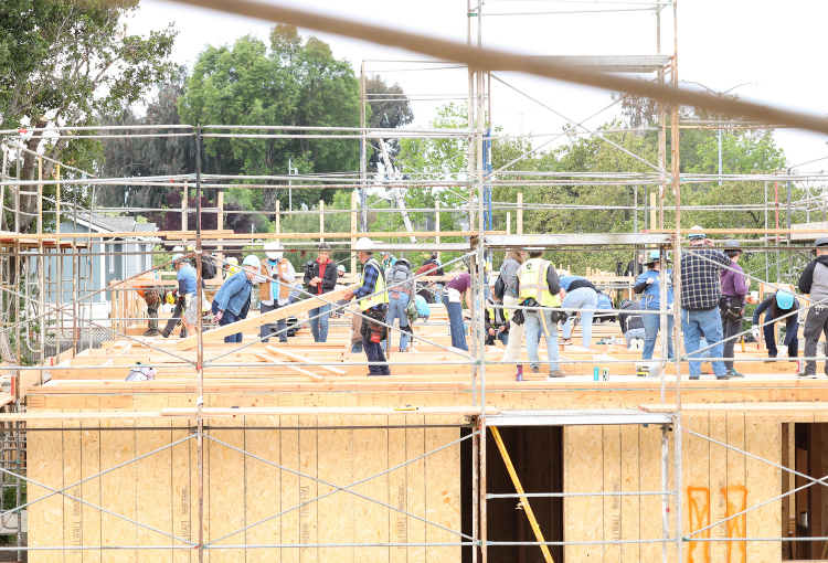 Volunteers building on the second story of a townhome.