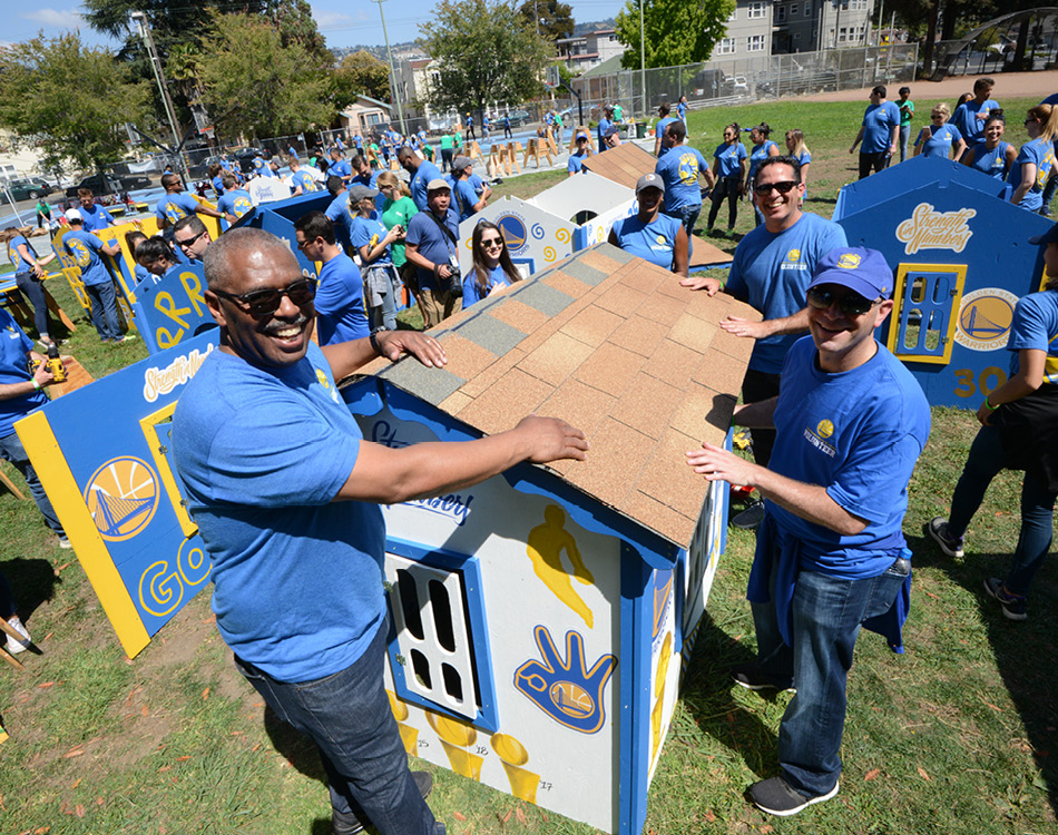 Habitat corporate volunteers with playhouse