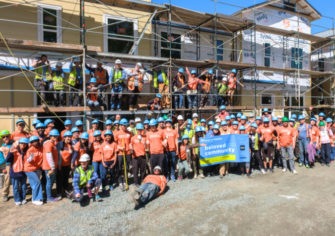 Group of volunteers from corporations and faith-based organizations at Habitat's Beloved Community build event