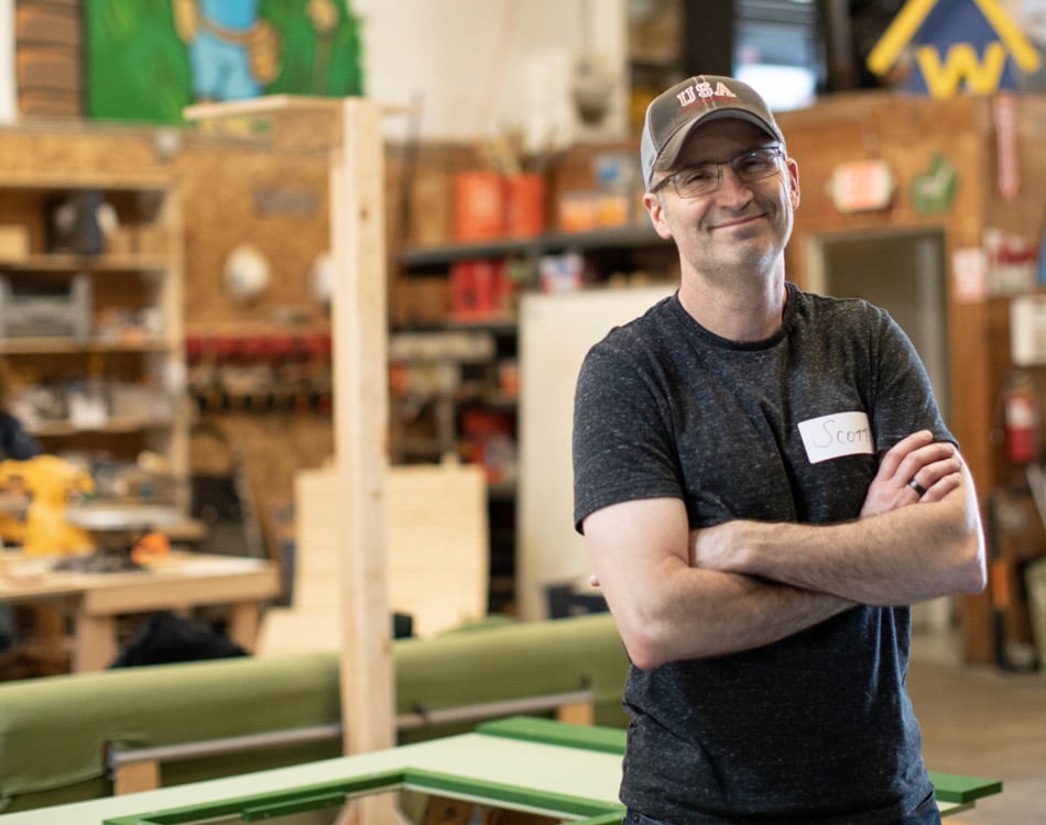 Smiling volunteer in wood shop