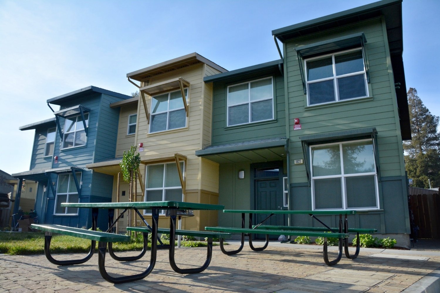 Renovated townhomes with picnic tables outside