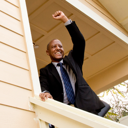 man celebrating in front of a house