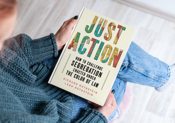 woman holding the book Just Action by Richard and Leah Rothstein