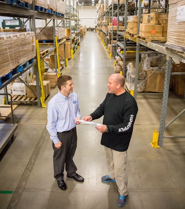 Two Men Talking in Warehouse