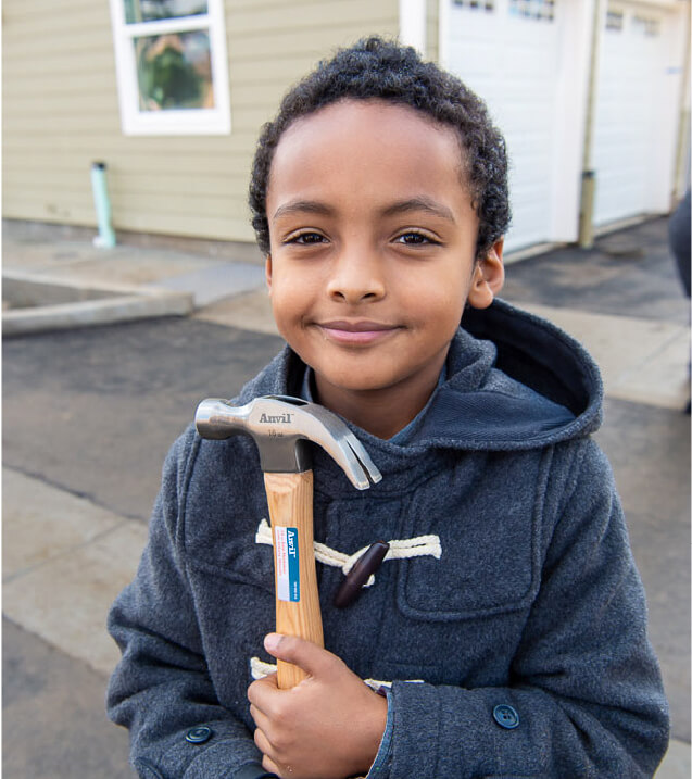 little boy holding a hammer